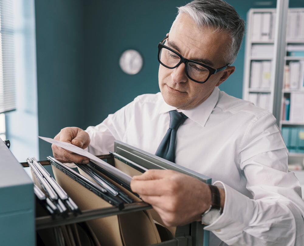 Man looking at records